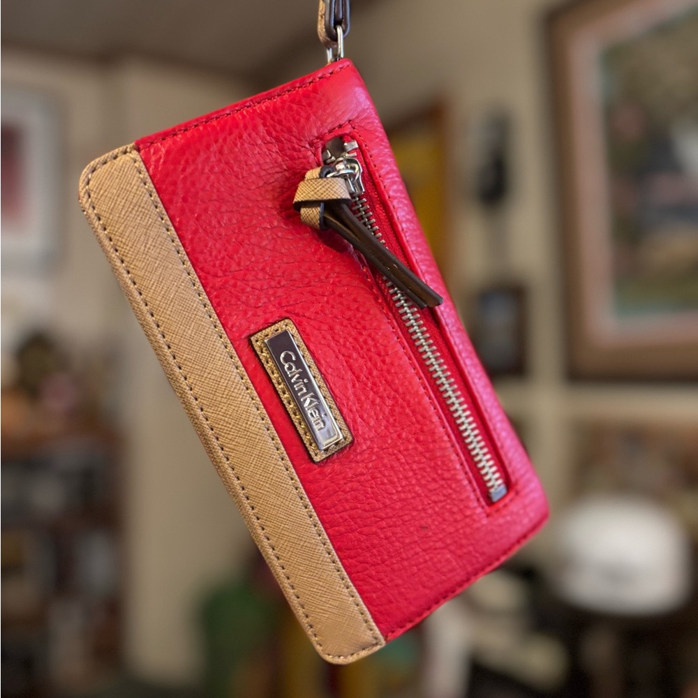 Calvin Klein red leather wristlet. LIKE NEW!! Never used in original box!!